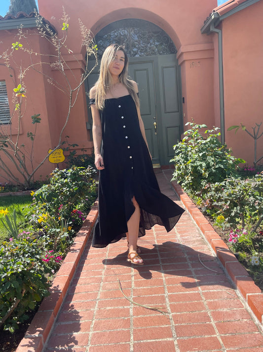 This romantic maxi dress has a breezy silhouette that's perfect for sunny climes. It has delicate shirred along the scooped neckline and lustrous mother-of-pearl buttons along the front. Wear it with strappy sandals and an oversized tote on your next trip.