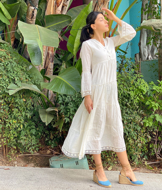 This peasant-style dress stands out for its classy shade and breezy silhouette. It's cut for a loose fit from cotton-voile and has a V-neckline and voluminous tiered skirt. Mika Maxi Dress is decorated with detailed lace edging. Contrast yours with boho-chic accessories!